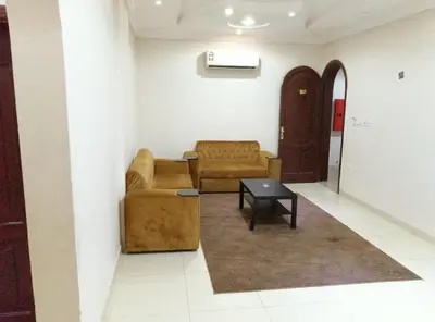 a living room with two couches and a table at 2332 Guest House in Irbid