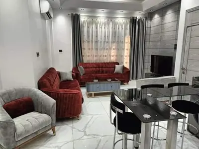 a living room with a couch and a table at Araregj home in Amman