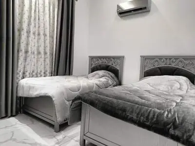 a bedroom with two twin beds and a window at Araregj home in Amman