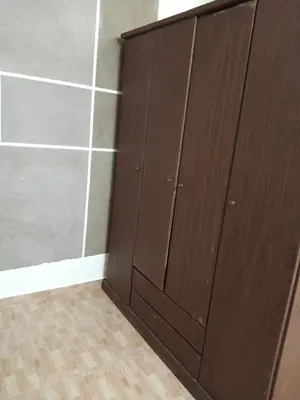 a closet with wooden doors in a room at شقة الياسمين العائلية الفاخرة in Amman