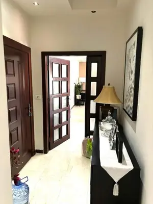 a room with a hallway with a table and a door at Maan 12 in Ma‘ān