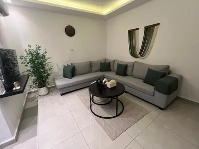 a living room with a couch and a table at Casa De Centre 2 in Amman