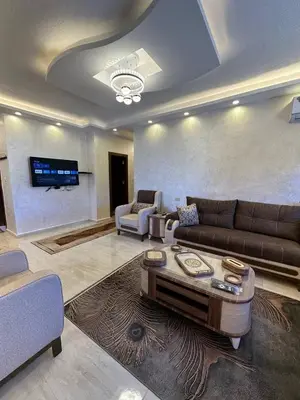 a living room with a couch and a table at 3 bed rooms apartment - 3 غرف نوم مفروشة دوار المشاغل عمان in Amman
