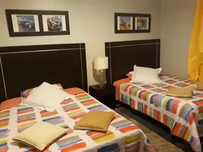 two beds sitting next to each other in a room at GOJORDAN INN in Irbid
