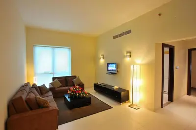 a living room with a couch and a television at GOJORDAN INN in Irbid