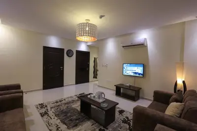 a living room with a couch and a tv at GOJORDAN INN in Irbid