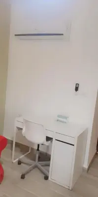 an office with a white desk and a chair at Lovely Studio appartment in a central location in Amman