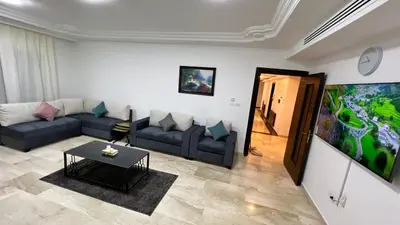 a living room with a couch and a table at شقة مفروشة اربع غرف نوم عبدون in Amman