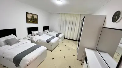 a hotel room with two beds and a mirror at شقة مفروشة اربع غرف نوم عبدون in Amman
