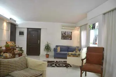 a living room with a blue couch and chairs at lomez House in Amman