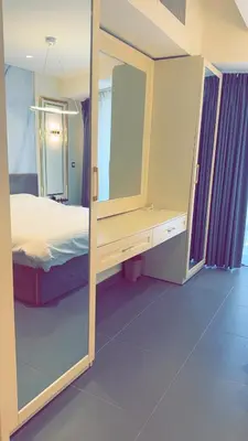 a bedroom with a large mirror and a bed at Amman Damac one bedroom boulevard Abdali استديو في داماك عمان الاردن in Amman