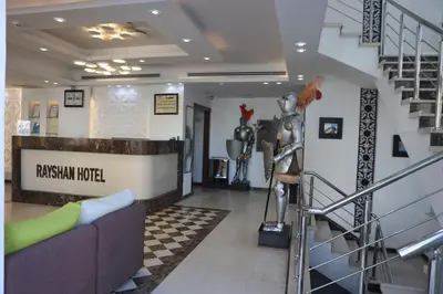 a lobby of araxan motel with a statue in the middle at Hotel Rayshan in Amman