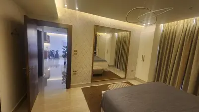 a bedroom with a bed and a large mirror at Amazing new apartment in the middle of Amman in Amman