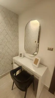 a desk with a chair and a mirror at Amazing new apartment in the middle of Amman in Amman