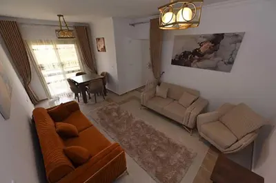 a living room with a couch and a table at Jordan House INN in Amman