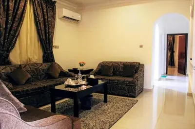 a living room with two couches and a coffee table at 360 INNn in Irbid