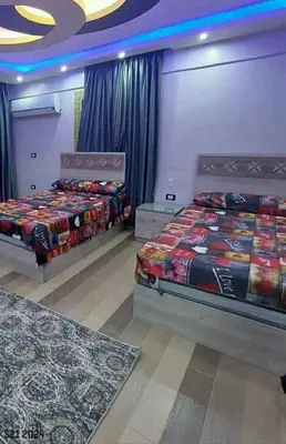 two beds in a room with two rugs at La bedouin in Amman