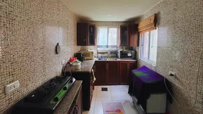 a small kitchen with a stove top oven in it at Al Karak House sharing Apt in Kerak