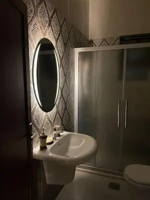 a bathroom with a sink and a mirror at Sunset Balcony Retreat - Spacious and Comfortable 2 Bedrooms 2 Bathrooms in Amman