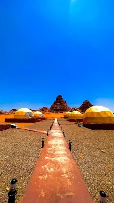 a long line of tents in the desert at Wadi Rum Luxure desert Camp in Wadi Rum