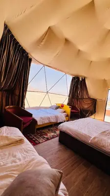 a room with three beds in a tent at Wadi Rum Luxure desert Camp in Wadi Rum