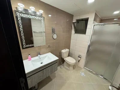 a bathroom with a toilet and a sink and a shower at COZY apt For long &short Stay in Amman