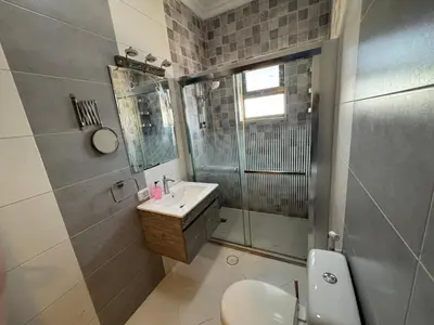 a bathroom with a toilet and a sink and a shower at COZY apt For long &short Stay in Amman