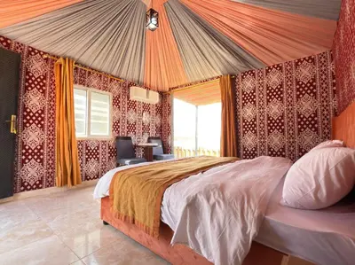a bedroom with a large bed and a window at Fadi camp in Wadi Rum