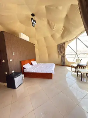 a bedroom with a bed and a large ceiling at Fadi camp in Wadi Rum