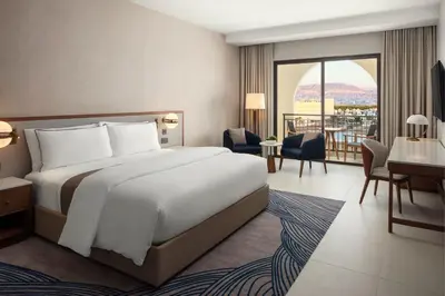 a hotel room with a bed and a balcony at The Westin Saraya Aqaba Resort & Spa in Aqaba