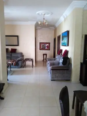 a living room with two couches and a couch at Ayola Apartment in Madaba