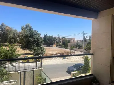 a view of a parking lot from a window at Elite Abdoun area, Amman, 2 Br, 5 guests in Umm Uthainah
