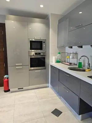 a kitchen with stainless steel appliances and a sink at Elite Abdoun area, Amman, 2 Br, 5 guests in Umm Uthainah