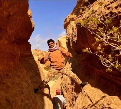 a man standing on a rock in a canyon at Dana horizon hotel in Dana