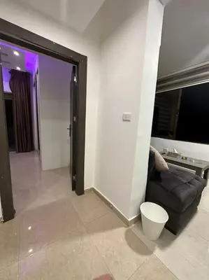 a living room with a couch and a table at abdoun rooftop 1bedroom kh&sh 03 in Amman