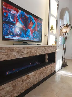 a flat screen tv on top of a fireplace at The heart of Jabal alweibdeh 2,000 SF entire apartment in Amman