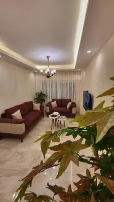 a living room with a couch and a table at Residents Specialists in Amman