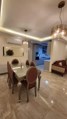 a living room with a table and chairs and a couch at Residents Specialists in Amman