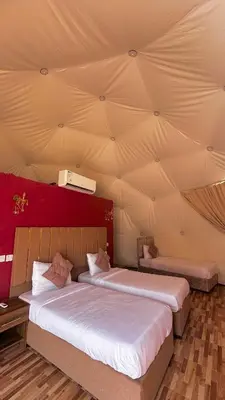 two beds in a room with a ceiling at Diamond luxury rum in Wadi Rum