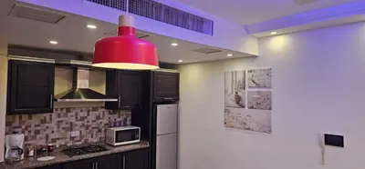 a kitchen with a red light hanging from a ceiling at 2 bedrooms apartment no 13 in Amman