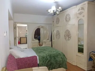 a bedroom with a large bed and a chandelier at 3030 Inn in Irbid