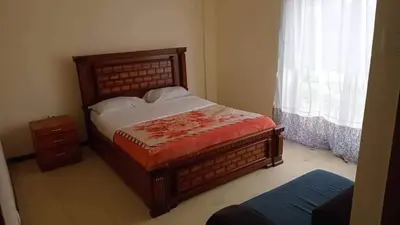 a bedroom with a large bed and a window at Go there Inn in Az Zarqa