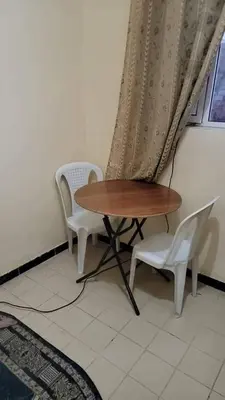 a table and two chairs and a table and chairs at Go there Inn in Az Zarqa