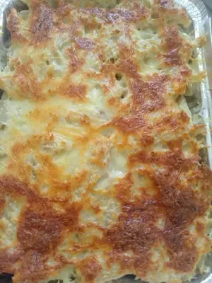 a close up of a cheese pizza in a container at Go there Inn in Az Zarqa