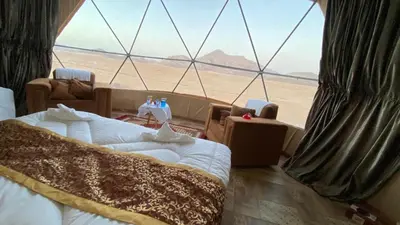 a room with a bed and a view of the desert at Msek wadi rum camp in Disah
