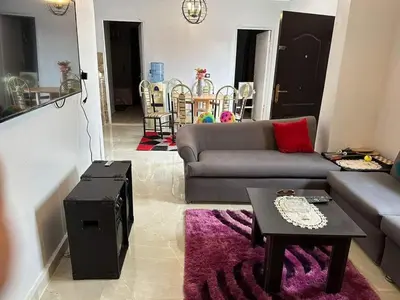 a living room with a couch and a table at Lotees House in Udhruḩ