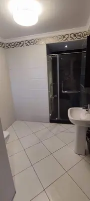 a bathroom with a shower and a toilet and a sink at Lotees House in Udhruḩ