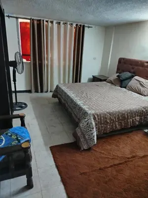 a bedroom with a bed and a window with curtains at شقة الراحة و الهدوء economic comfortable flat in Amman