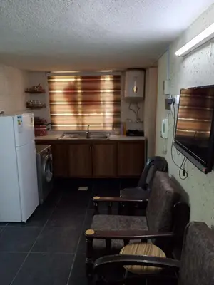 a kitchen with a sink and a refrigerator at شقة الراحة و الهدوء economic comfortable flat in Amman