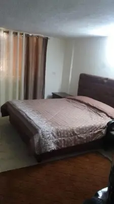 a bed sitting in a bedroom with a window at شقة الراحة و الهدوء economic comfortable flat in Amman